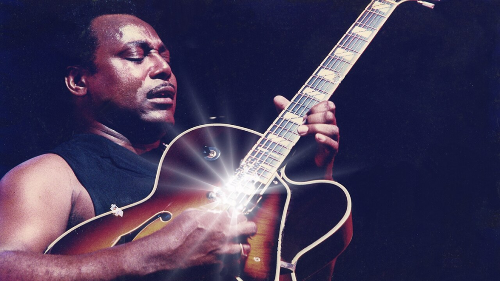 George Benson performs with electric guitar