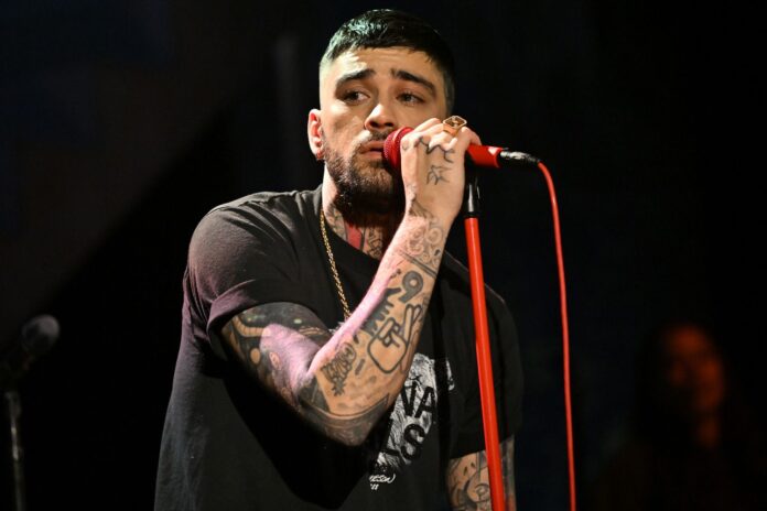 Zayn Malik singing into microphone