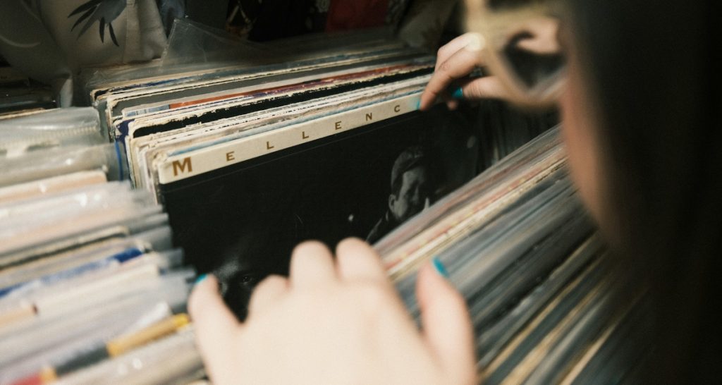 Person flips through vinyl records