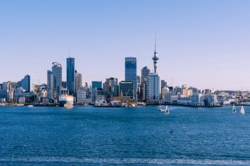 Auckland cityscape with boats at sunset