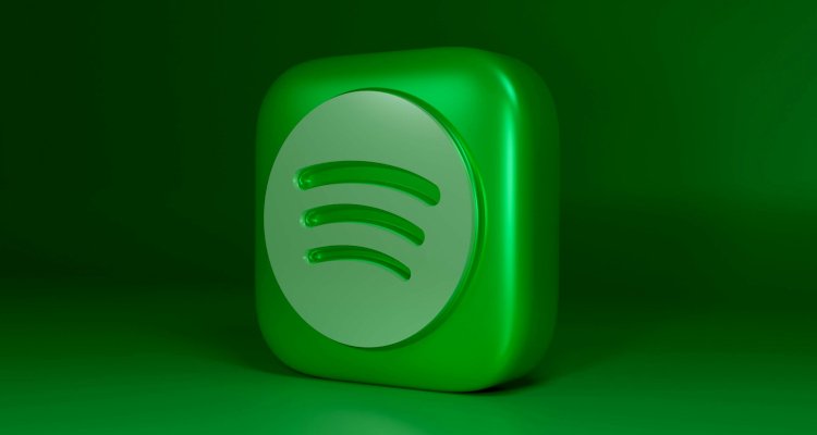 Green Spotify logo on dark background