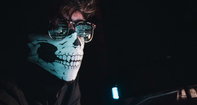 Person wearing skull mask and glasses