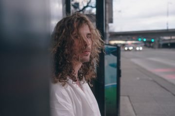 Man with long hair performing outdoors