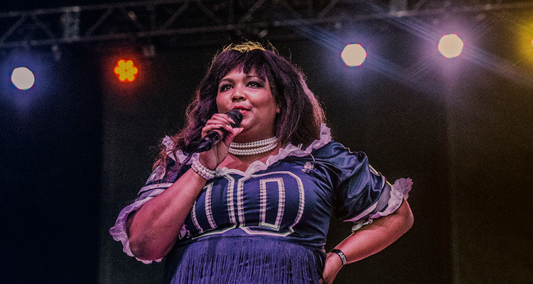 Lizzo performing in sparkly pink dress