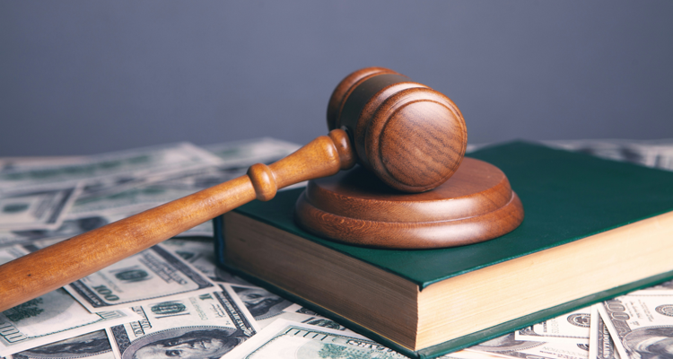 Wooden gavel resting on legal books