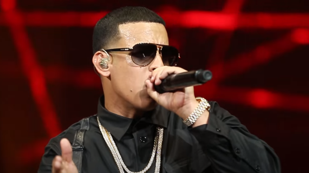 Daddy Yankee speaking into microphone onstage