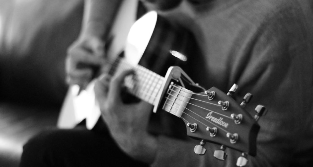 Black and white guitarist performing