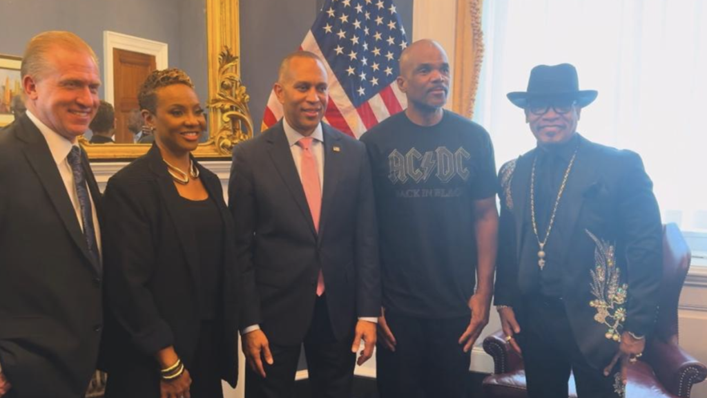 Five people standing at news conference