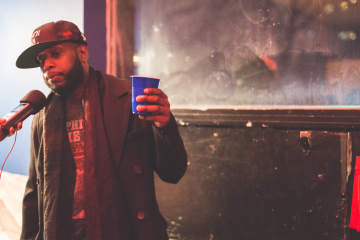 Talib Kweli holding blue cup