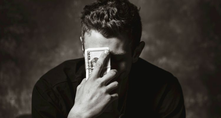 Man holding cash near face