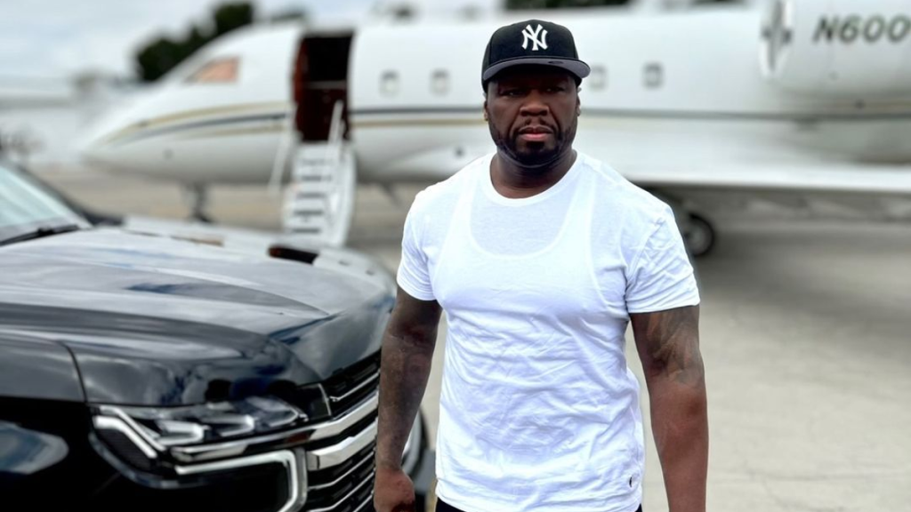 50 Cent standing near private jet