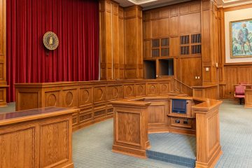 Empty courtroom with red drapes