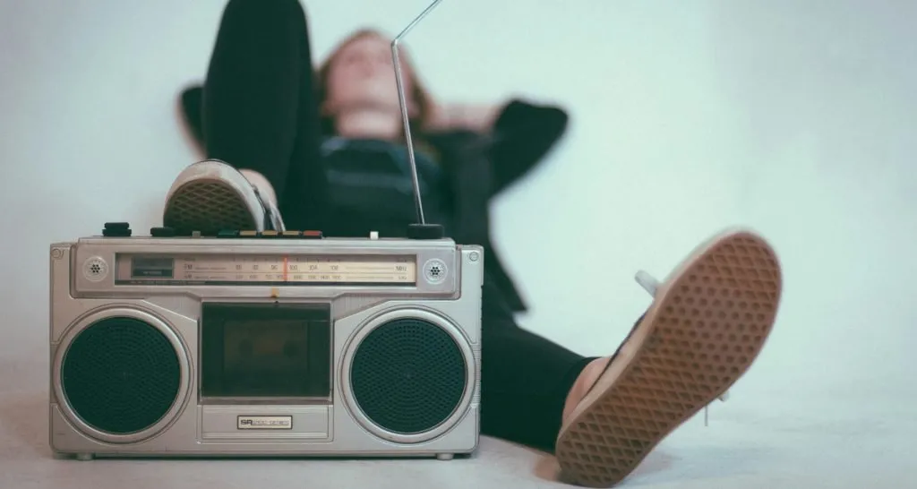 Person lying with vintage radio