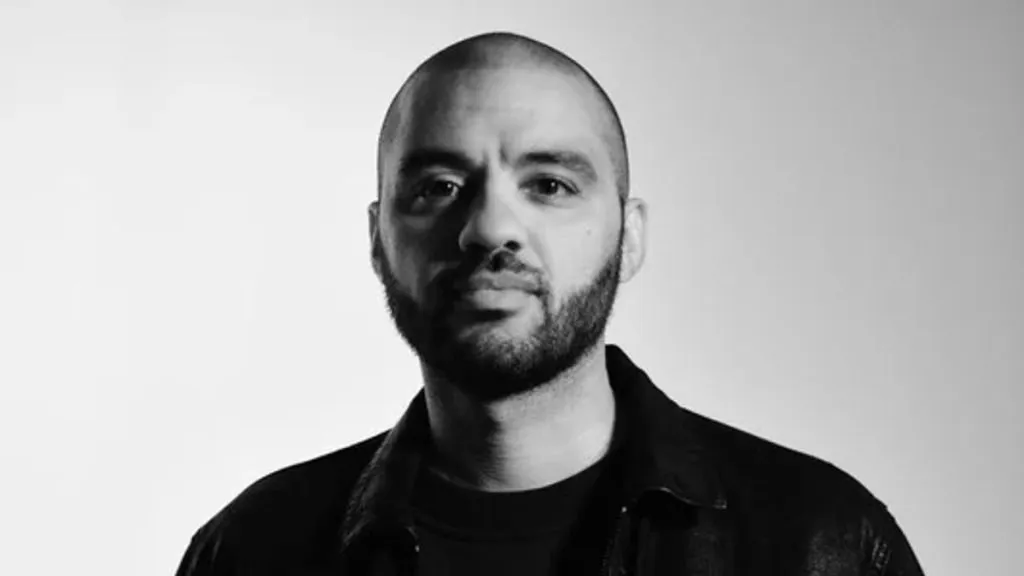 Bald man wearing black jacket headshot